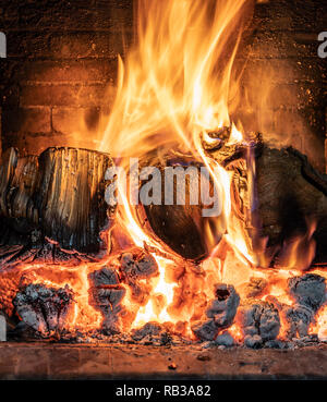 A blazing log fire in an open fireplace Stock Photo