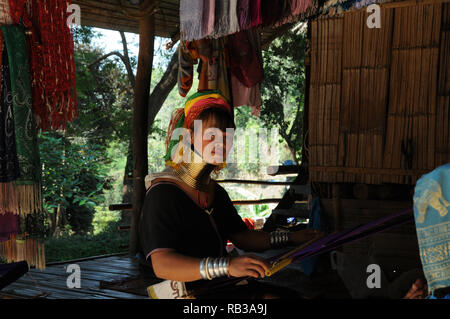 Young Kayan Lahwi woman weaving in a remote mountain village, Chiang Mai Province, Thailand