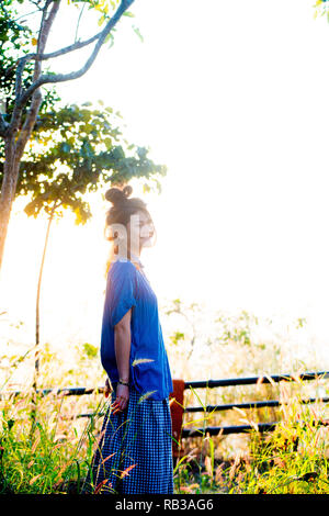 Asian female model poses for pictures in the outdoors Stock Photo