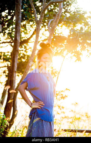 Asian female model poses for pictures in the outdoors Stock Photo