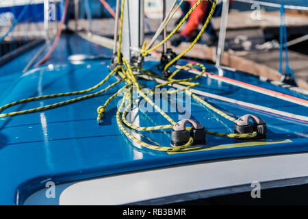 Close-up nautical knot rope tied around stake on boat or ship, boat mooring rope. Stock Photo