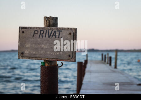 Privacy sign at the start of a vintage jetty/pier. Stock Photo