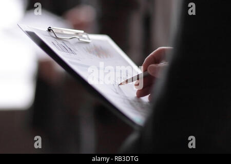 close up.businessman with a clipboard on the background of coll Stock Photo
