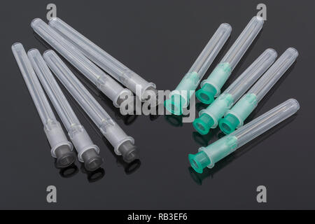 Close-up hypodermic needles. Specifically BD Microlance brand- Green 21G 1' / 0.8x25mm & Grey 22G 1 1/2' 0.7/40mm. Metaphor NHS, inoculation, flu jab Stock Photo