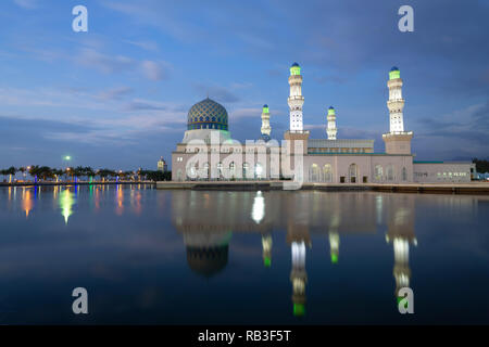 Beautiful Kota Kinabalu City Mosque reflected in lagoon during dusk sunset blue hour. Stock Photo