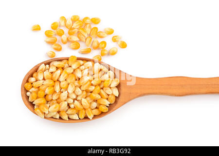 The corn seeds in wooden spoon isolated on white background. Top view. Flat lay Stock Photo