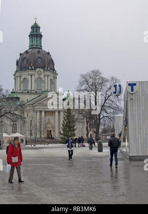 STOCKHOLM, SWEDEN - DECEMBER 29, 2018: City scene at Odenplan with Gustaf Vasa church people and entrance to commuter train and subway on December 29, Stock Photo