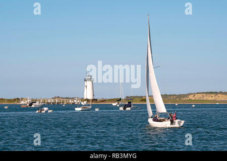 Sailing in Edgartown harbor by Edgartown lighthouse on Martha’s Vineyard island on a warm summer day. Stock Photo