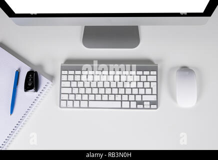 Workplace with computer and wireless keyboard and mouse, notebook and car keys on white background	 Stock Photo