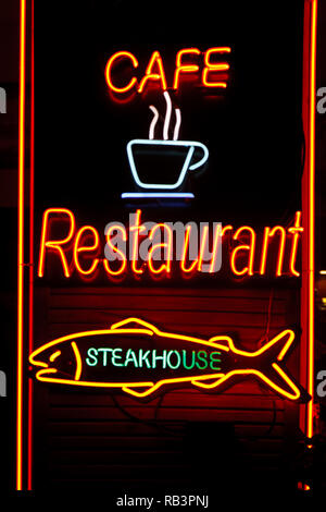 neon cafe restaurant steakhouse on wooden wall Stock Photo