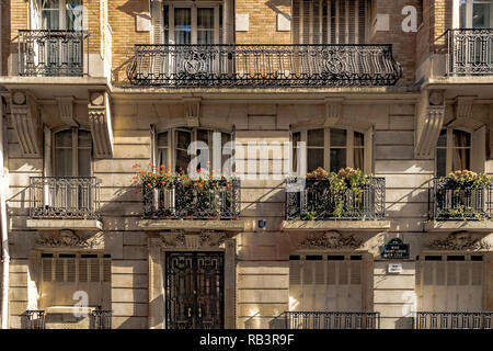 Apartment building with wrought iron balconies and flower boxes on Rue Saint-Louis-en-l'Île ,Paris ,France Stock Photo
