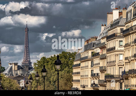 Dark clouds surround  The Eiffel Tower as seen  from Rue Soufflot , a street lined with impressive apartment buildings ,Paris ,France Stock Photo