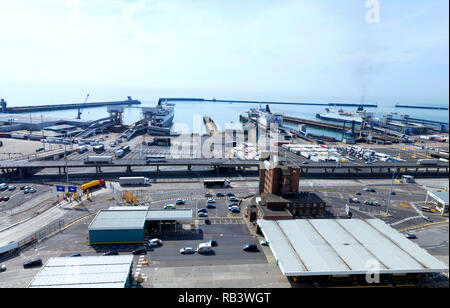 Busy Port of Dover docks . Cars and trucks with cargo queuing to embark ferry for channel crossing . Stock Photo