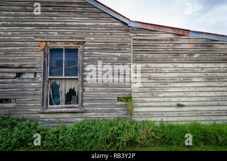 Side of an abandoned and weathered old house, soon to be torn down Stock Photo