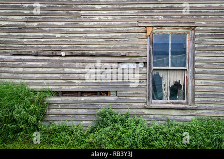 Side of a worn and weathered old house, soon to be torn down Stock Photo