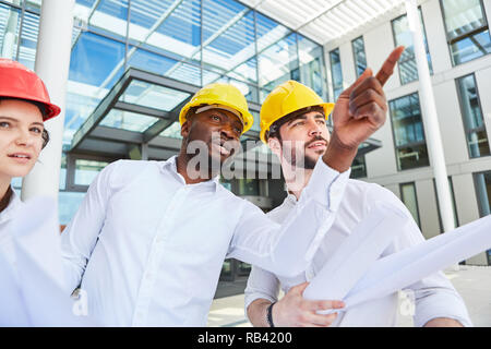 Site managers and architects team make a decision on a construction project Stock Photo