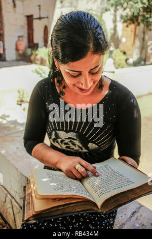 Reading a medical treaty by Fariz Ibn Zafer al Jazin. Bimaristan An Nouri, now Museum for Medicine and Arabic Sciences. Damascus. Syria, Middle East Stock Photo