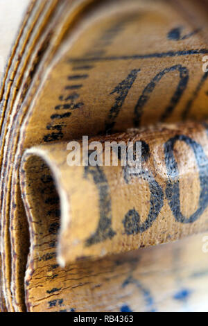 Old measuring tape isolated on white background, close-up