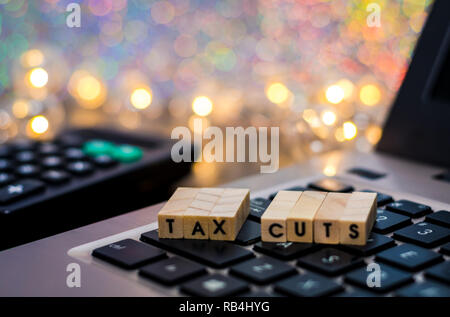 Tax Cuts still life business finance concept with laptop, stock chart, shallow DOF Stock Photo