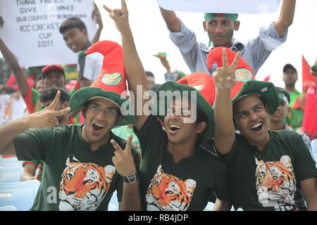 Bangladesh fans flash the V-sign during the ICC Cricket World Cup 2011 against England at Zohur Ahmed Chowdhury Stadium. Chittagong, Bangladesh. Stock Photo
