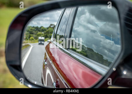 Photo of a car mirror during a drive Stock Photo