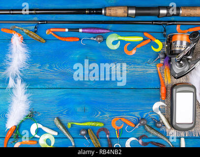 Close up of spinning with the fishing reel in the hand, fishing hook on the  line with the bait in the left hand against the background of the water.  6533276 Stock Photo