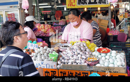 Hengchun, Taiwan - Dec.8, 2018 - Bussy egg lady selling fresh eggs in the Hengchun food court. Stock Photo