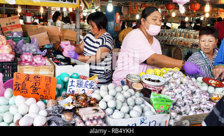 Hengchuni, Taiwan - Dec.8, 2018 - Busy food court in Hengchun,Taiwan with egg lady selling fresh eggs. Stock Photo