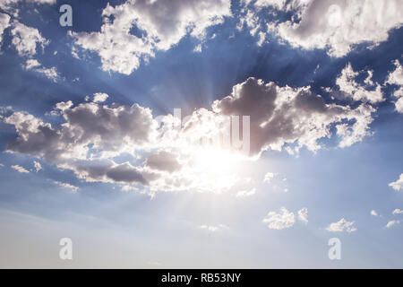 sunlight bursting in clouds and blue sky Stock Photo