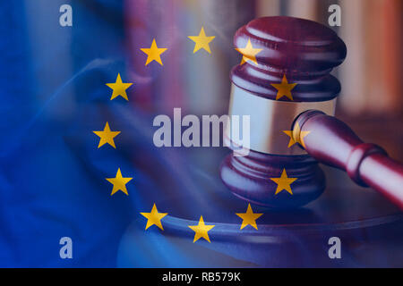 Strike of court gavel viewed in close-up with EU flag. Full frame background concept Stock Photo