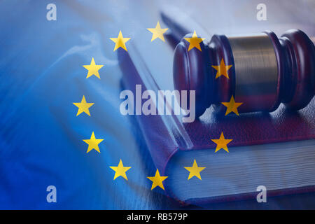 Judgement gavel on the code of European Union laws, with EU flag as a full frame legal system background concept Stock Photo