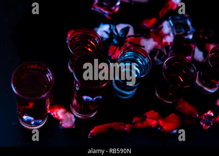 creepy halloween party cocktails with blood, spiders and ice cubes, drinks at party Stock Photo