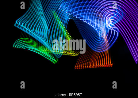 Abstract light blue, purple, red,green and yellow trails in random motion background image. Striped Neon Lights in Rainbow Colors  Stock Photo