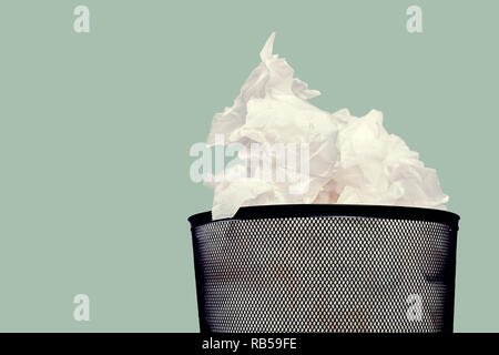 Office basket with crumpled paper isolated on white background