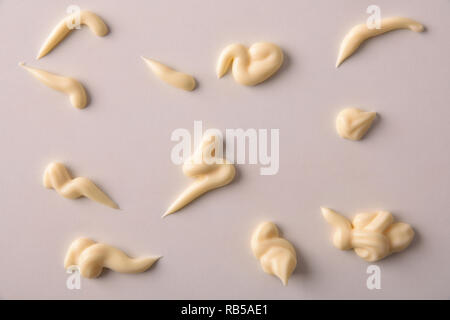 Set of mayonnaise splashes on white wooden table. Top view. Horizontal composition. Stock Photo