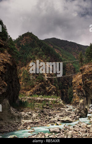 Double bridge over a river in Nepal. Photographed while walking the Everest Base Camp Trek. Stock Photo