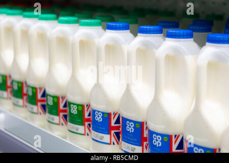 Plastic bottles of milk on sale in a supermarket shop in the UK. Stock Photo