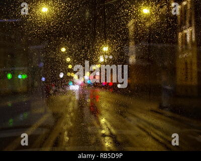 Rainy night from tram windows defocused road view Stock Photo