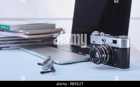 Computer keyboard, mouse and camera lie on table. Stock Photo