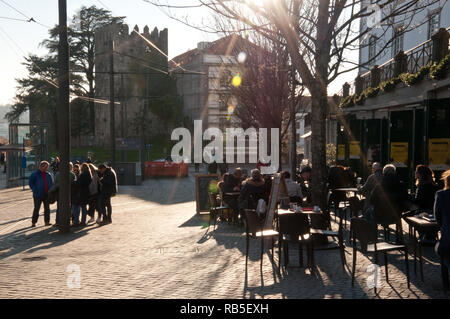 People on the restaurants at Porta do Sol street in Porto, Portugal Stock Photo