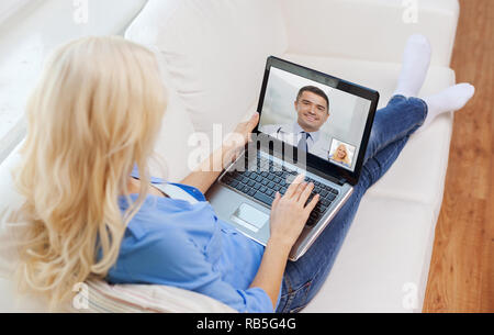 patient having video call with doctor on laptop Stock Photo