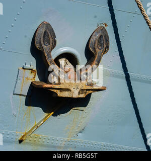 Rusty ship anchor in up position Stock Photo