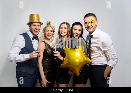 happy friends with golden party props posing Stock Photo