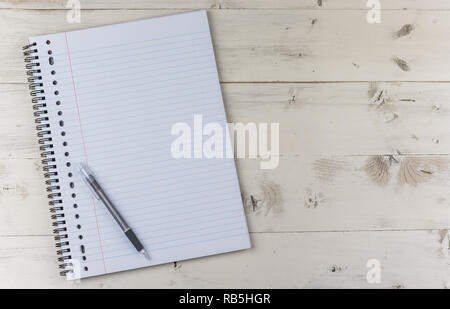 Notepad and pen on a white wooden table Stock Photo