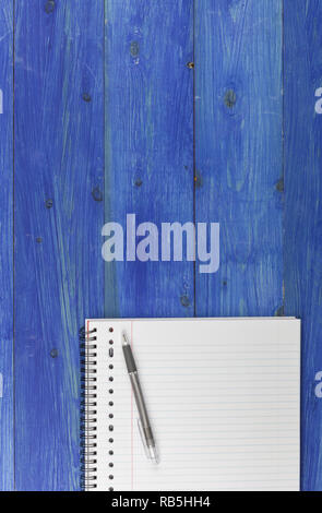 Notepad and pen on a blue wooden table Stock Photo