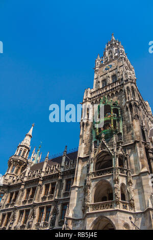 A great close low angle view of the neo-Gothic tower of Munich's New Town Hall (Neues Rathaus) including the clock chimes. The bell play... Stock Photo