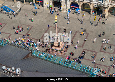 Great aerial view of the Mary's Square (Marienplatz), a popular pedestrian zone in Munich, and the famous Marian column (Mariensäule) with the golden... Stock Photo