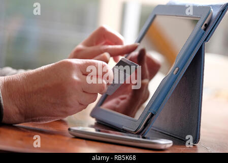 senior female using credit card for online payment Stock Photo