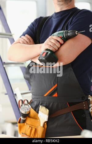 Arms of worker using electric drill Stock Photo