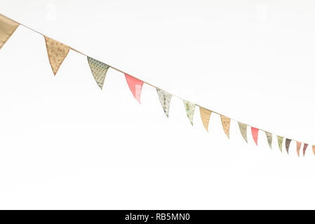 Vintage triangular pennants hanging with the blue sky in the background. Stock Photo